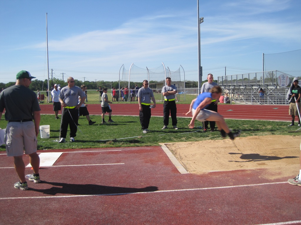 15th MI Soldier assist during the long jump competition