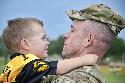 Col. Daniel Hurlbut, the operations officer-in-charge for the 1st Cavalry Division, holds his son after a redeployment ceremony April 20 on Cooper Field. The division headquarters had just returned from a year deployment in Afghanistan. (U.S. Army Photo by Sgt. Kim Browne, 1st Cav. Div. Public Affairs)