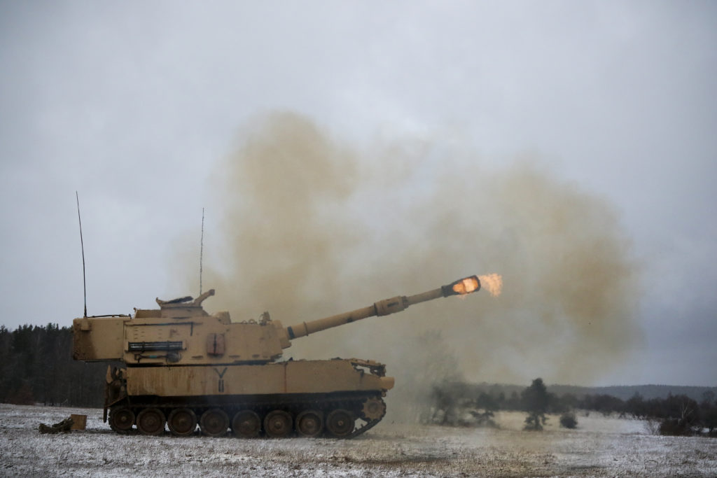 An M109A6 Paladin, assigned to Bravo Battery, 1st Battalion, 82nd Field Artillery Regiment, 1st Armored Brigade Combat Team, 1st Cavalry Division, fires its main gun at a range during Table Six qualifications on U.S. Army Garrison Bavaria in Grafenwoehr, Germany, Jan. 9, 2019. Ironhorse Soldiers are training in Germany as they close out their rotation across Europe in support of Atlantic Resolve. (U.S. Army National Guard photo by Sgt. Lisa Vines, 382nd Public Affairs Detachment, 1st ABCT, 1st CD/Released)